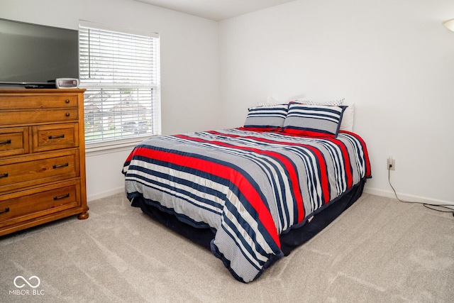 carpeted bedroom with baseboards
