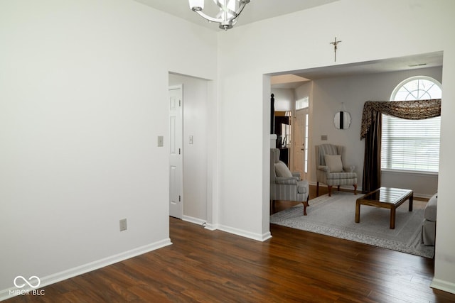 living area with baseboards and dark wood finished floors
