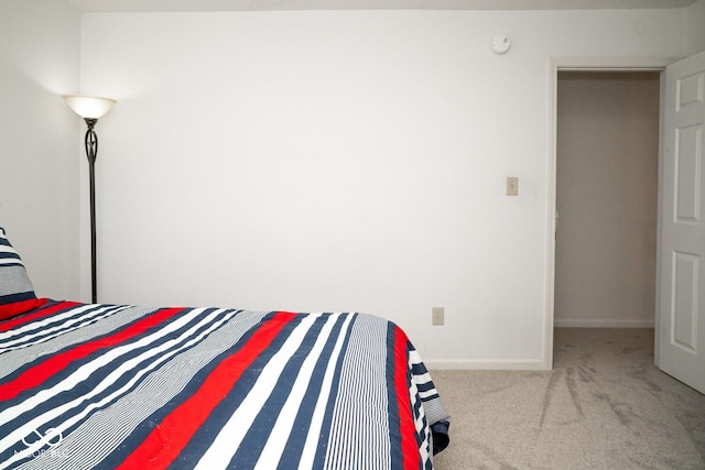 carpeted bedroom featuring baseboards