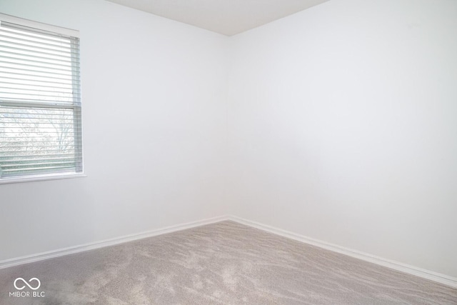 carpeted spare room with baseboards