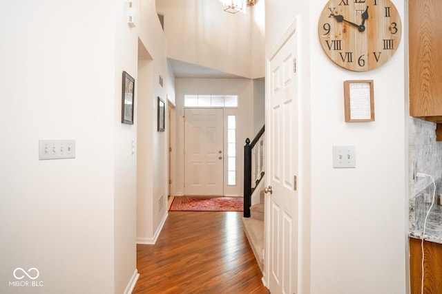 interior space featuring stairway, wood finished floors, visible vents, and baseboards