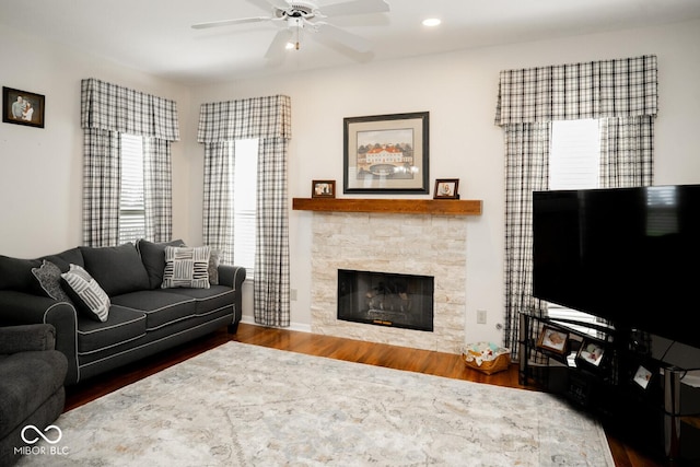 living room featuring recessed lighting, wood finished floors, ceiling fan, and a fireplace