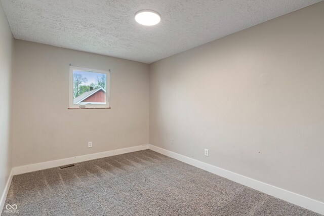 2935 Highland Pl, Indianapolis, IN 46208 - empty room featuring baseboards, visible vents, a textured ceiling, and carpet
