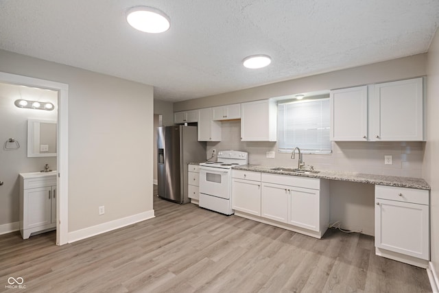 2935 Highland Pl, Indianapolis, IN 46208 - kitchen featuring stainless steel fridge, light wood finished floors, a sink, and white electric stove