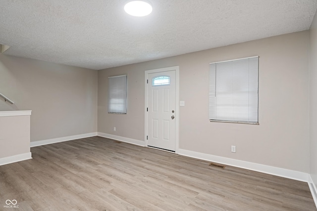 2935 Highland Pl, Indianapolis, IN 46208 - entrance foyer with baseboards, visible vents, wood finished floors, and a textured ceiling