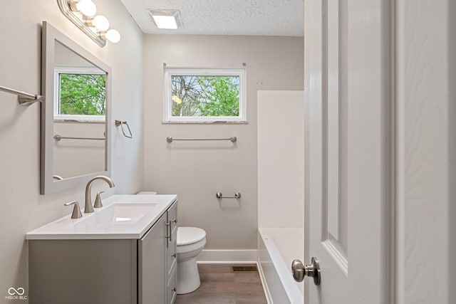 2935 Highland Pl, Indianapolis, IN 46208 - full bath featuring vanity, toilet, visible vents, baseboards, and wood finished floors