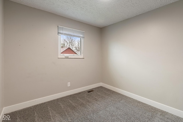 2935 Highland Pl, Indianapolis, IN 46208 - unfurnished room featuring baseboards, visible vents, carpet floors, and a textured ceiling