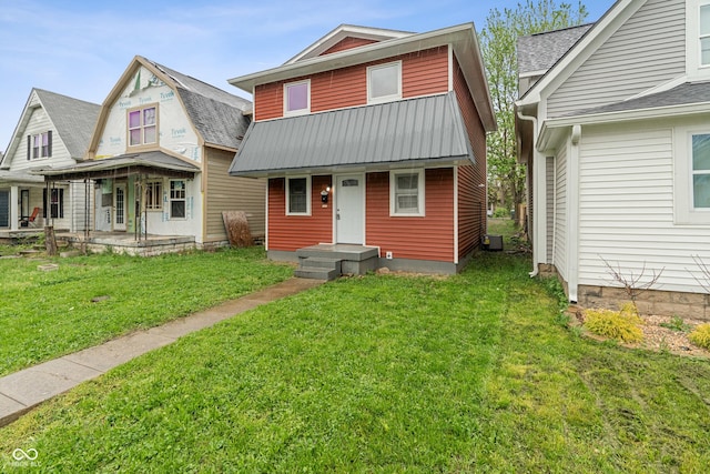 2935 Highland Pl, Indianapolis, IN 46208 - view of front of house with covered porch, central AC unit, a front lawn, and metal roof