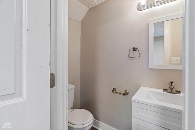 2935 Highland Pl, Indianapolis, IN 46208 - bathroom featuring toilet, a textured ceiling, and vanity
