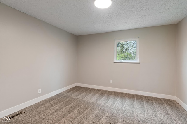2935 Highland Pl, Indianapolis, IN 46208 - carpeted empty room with baseboards, visible vents, and a textured ceiling
