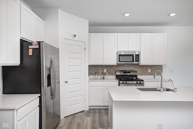 7265 Governors Row, Avon, IN 46123 - kitchen with white cabinetry, light wood-type flooring, appliances with stainless steel finishes, and a sink