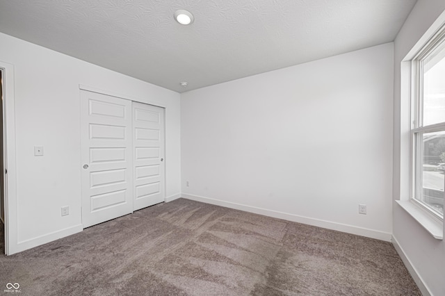 7265 Governors Row, Avon, IN 46123 - unfurnished bedroom with a closet, multiple windows, and carpet flooring