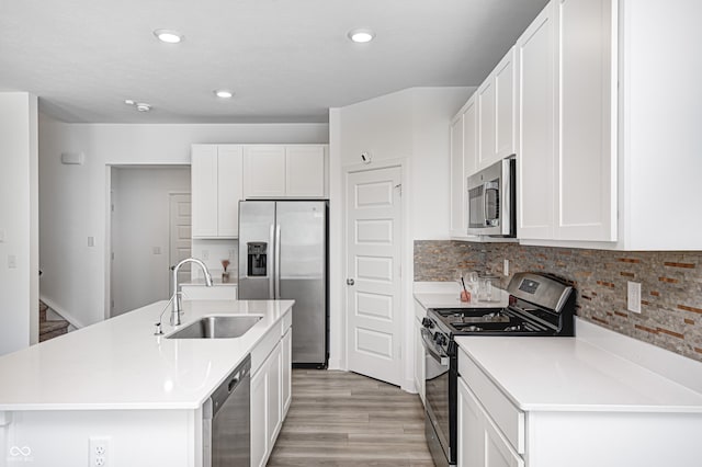 7265 Governors Row, Avon, IN 46123 - kitchen with white cabinets, a sink, stainless steel appliances, recessed lighting, and light wood finished floors