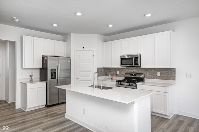 7265 Governors Row, Avon, IN 46123 - kitchen featuring tasteful backsplash, appliances with stainless steel finishes, light countertops, light wood finished floors, and a sink