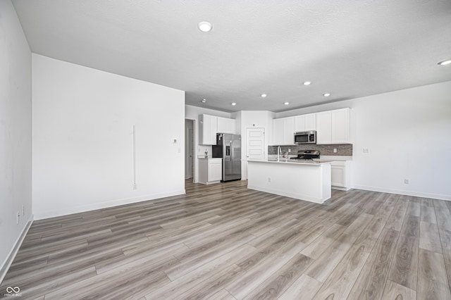 7265 Governors Row, Avon, IN 46123 - kitchen featuring recessed lighting, appliances with stainless steel finishes, a sink, light wood-type flooring, and open floor plan