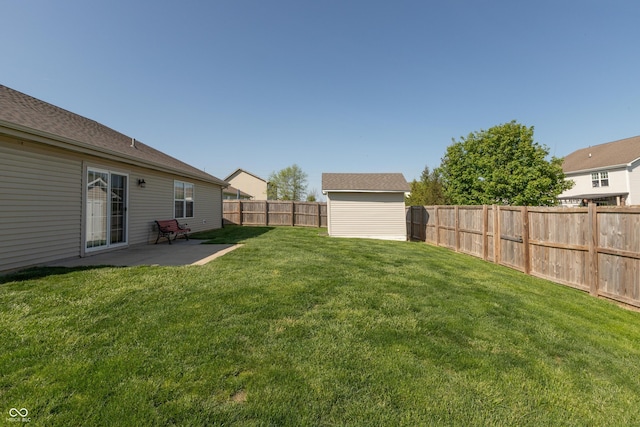 view of yard with an outdoor structure, a fenced backyard, a patio area, and a storage unit
