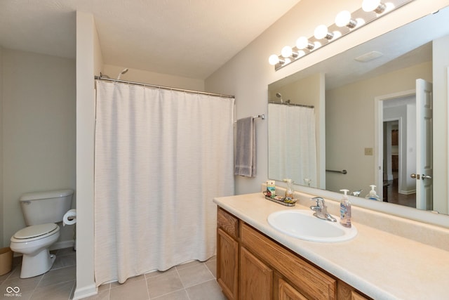 full bathroom with vanity, tile patterned floors, and toilet