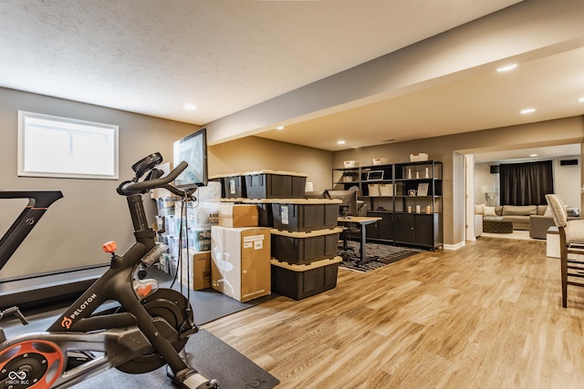 workout area with recessed lighting and wood finished floors
