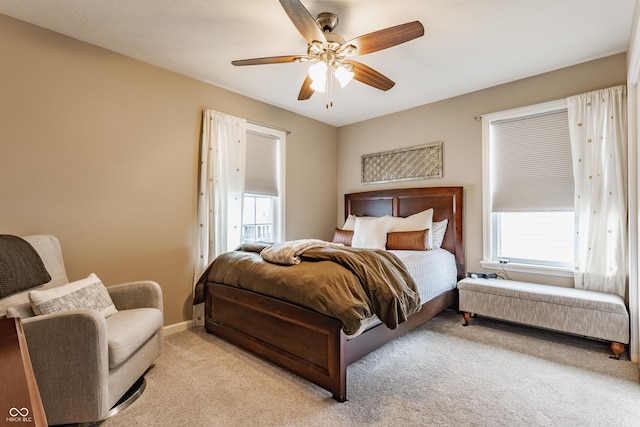 bedroom with baseboards, light carpet, and ceiling fan