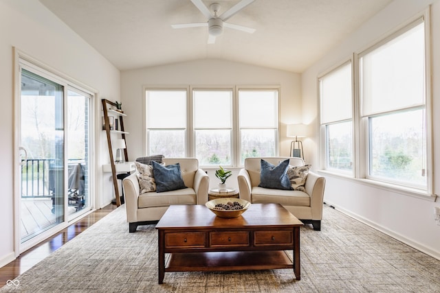 living room featuring baseboards, wood finished floors, ceiling fan, and lofted ceiling