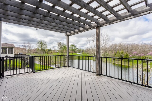 wooden deck featuring a water view and a pergola