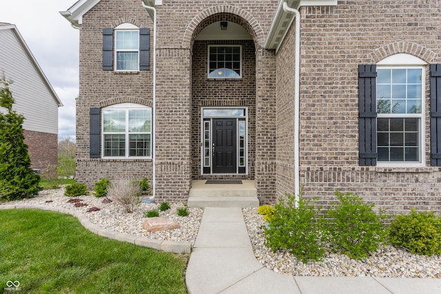 property entrance featuring brick siding