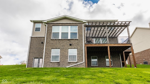 back of property featuring a deck, brick siding, central air condition unit, and a lawn