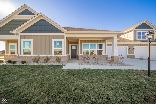 craftsman inspired home featuring a front lawn, brick siding, a shingled roof, board and batten siding, and concrete driveway