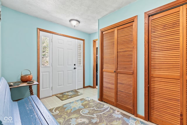 1301 N Maple St, Veedersburg, IN 47987 - entryway featuring baseboards, a textured ceiling, and light tile patterned floors