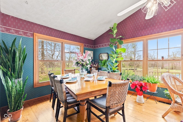 1301 N Maple St, Veedersburg, IN 47987 - dining area featuring vaulted ceiling, baseboards, wallpapered walls, ceiling fan, and wood-type flooring