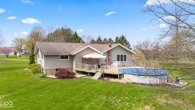1301 N Maple St, Veedersburg, IN 47987 - rear view of property featuring a lawn, a wooden deck, a covered pool, and a chimney