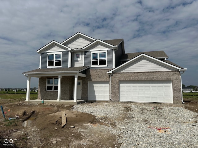 210 Aster Way, Greenfield, IN 46140 - view of front of house with a porch, gravel driveway, and brick siding