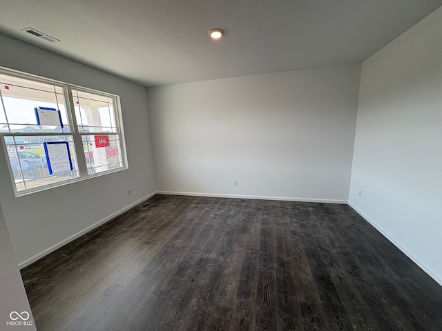 210 Aster Way, Greenfield, IN 46140 - spare room featuring dark wood-type flooring and baseboards