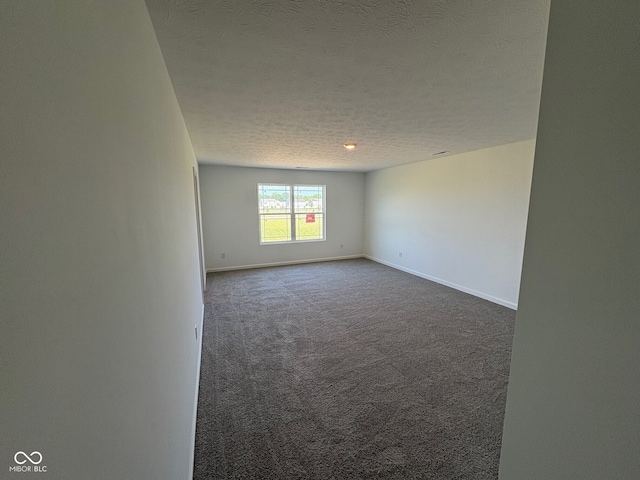210 Aster Way, Greenfield, IN 46140 - spare room with a textured ceiling and dark colored carpet