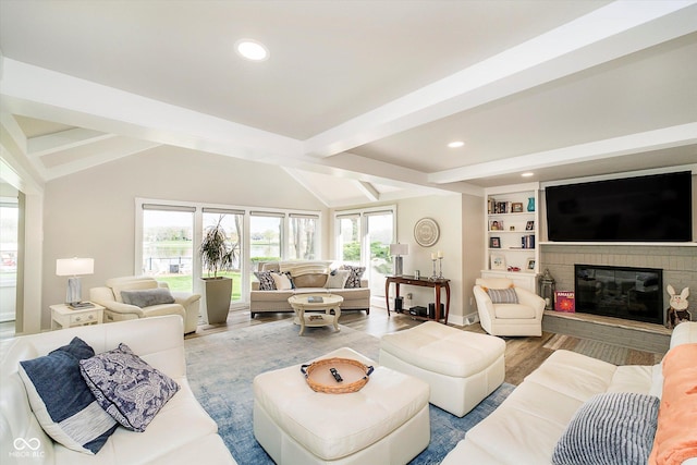 living room with wood finished floors, lofted ceiling with beams, baseboards, a brick fireplace, and recessed lighting