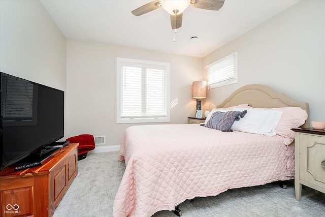carpeted bedroom with ceiling fan, baseboards, and visible vents