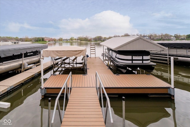 view of dock with boat lift and a water view