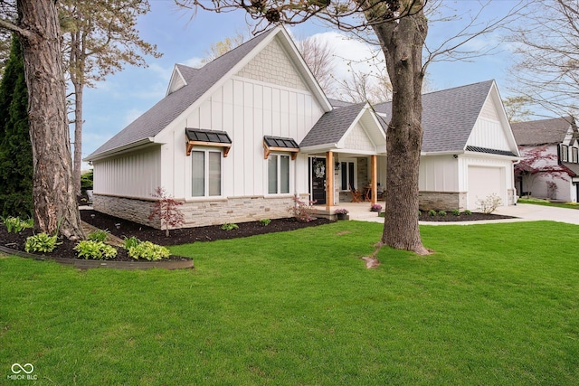 modern farmhouse style home with a shingled roof, concrete driveway, board and batten siding, stone siding, and a front yard