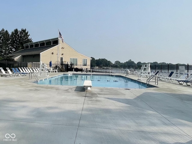 pool with fence and a patio