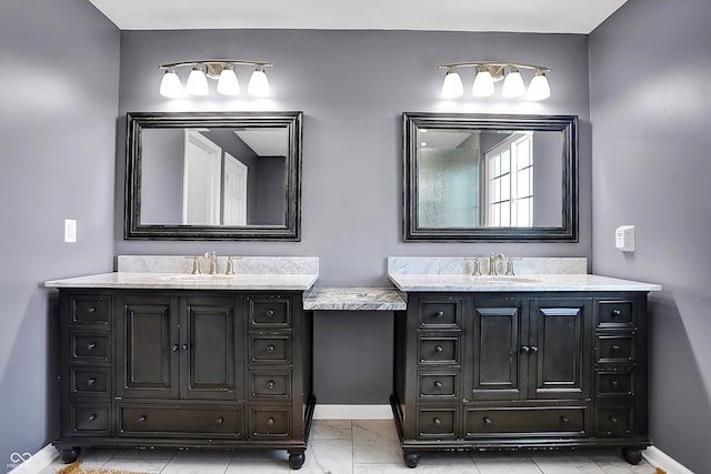 13836 Fieldcrest Dr, Mccordsville, IN 46055 - bathroom featuring two vanities, baseboards, and a sink
