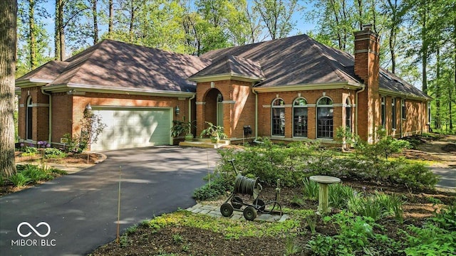 10561 Wilson Rd, Brownsburg, IN 46112 - view of front of property with brick siding, driveway, a chimney, and a garage
