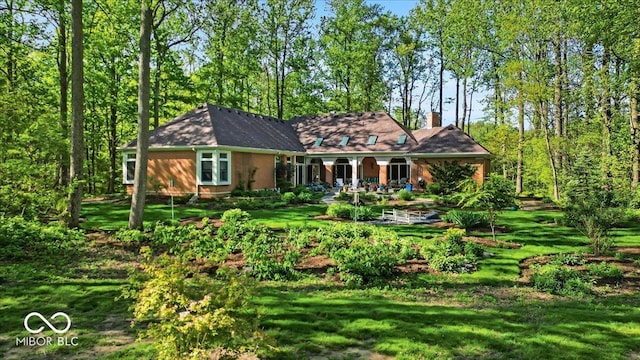 10561 Wilson Rd, Brownsburg, IN 46112 - view of front of property with a porch, a front lawn, and a chimney