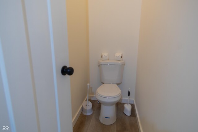2302 Prospect St, Indianapolis, IN 46203 - bathroom featuring baseboards, wood finished floors, and toilet