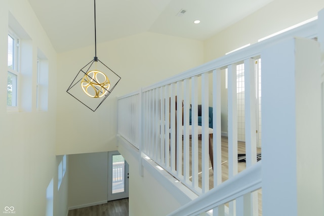 2302 Prospect St, Indianapolis, IN 46203 - stairs with lofted ceiling, a notable chandelier, and wood finished floors