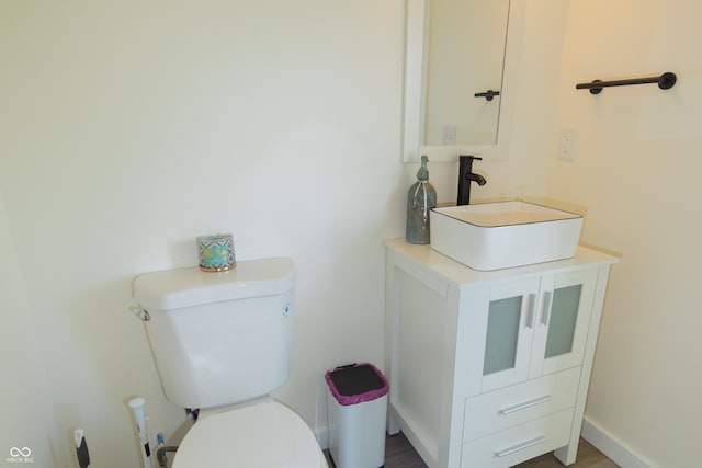 2302 Prospect St, Indianapolis, IN 46203 - bathroom featuring baseboards, vanity, and toilet