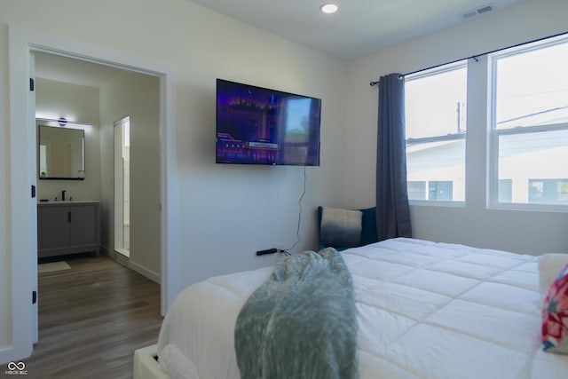 2302 Prospect St, Indianapolis, IN 46203 - bedroom featuring a sink, wood finished floors, baseboards, visible vents, and recessed lighting