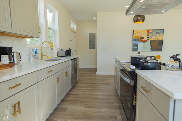 2302 Prospect St, Indianapolis, IN 46203 - kitchen with stainless steel dishwasher, light wood-style flooring, a sink, recessed lighting, and black / electric stove