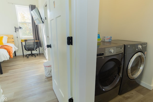 2302 Prospect St, Indianapolis, IN 46203 - washroom with separate washer and dryer, baseboards, light wood finished floors, and laundry area