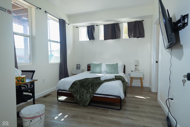 2302 Prospect St, Indianapolis, IN 46203 - bedroom with baseboards, wood finished floors, and visible vents