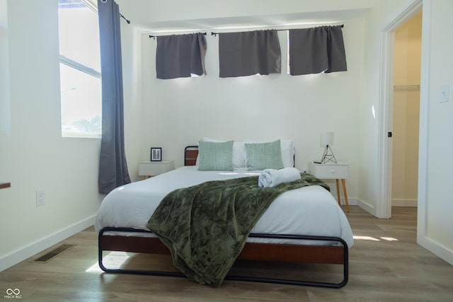 2302 Prospect St, Indianapolis, IN 46203 - bedroom featuring wood finished floors, visible vents, and baseboards